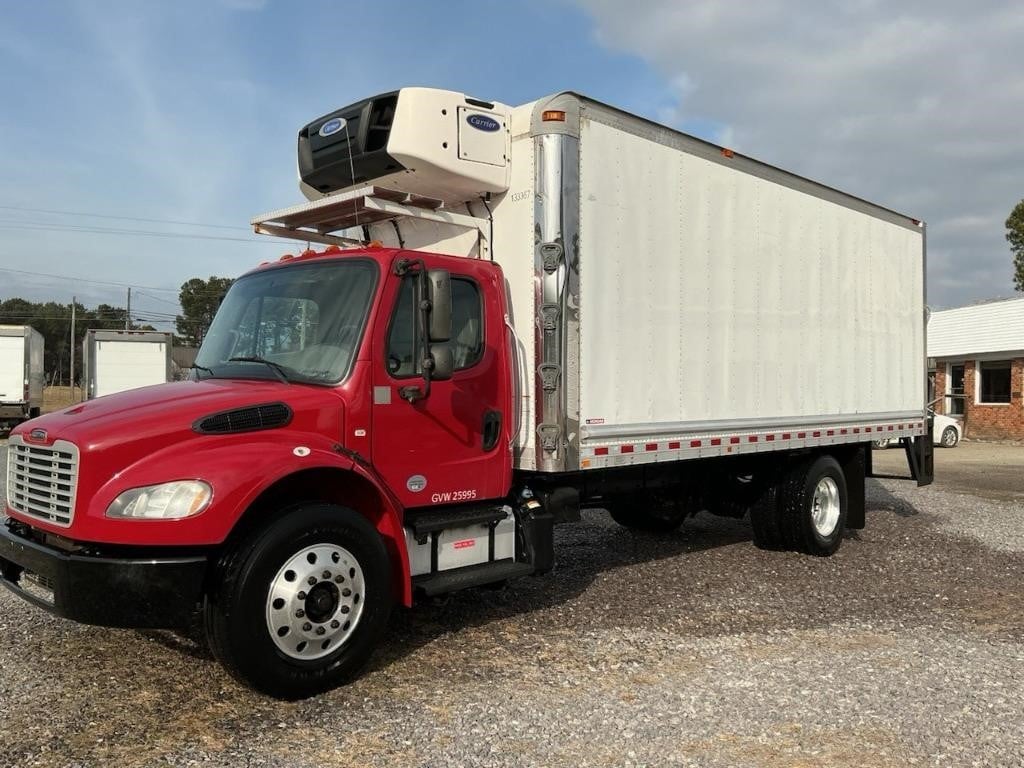 Side view of a truck with a red cab and a white body